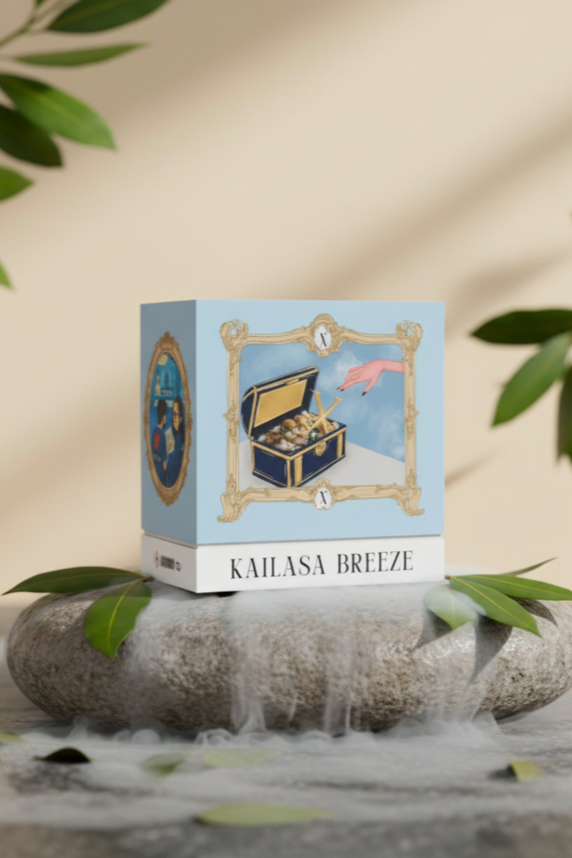 Studio product shot of the XAZINA 'Kailasa Breeze' perfume box, featuring a blue and gold illustration of a hand reaching into a treasure chest filled with gold and jewels. The box is set on a grey stone surrounded by green leaves and white mist. Represents the XAZINA brand story of luxury fragrance and discovery.
