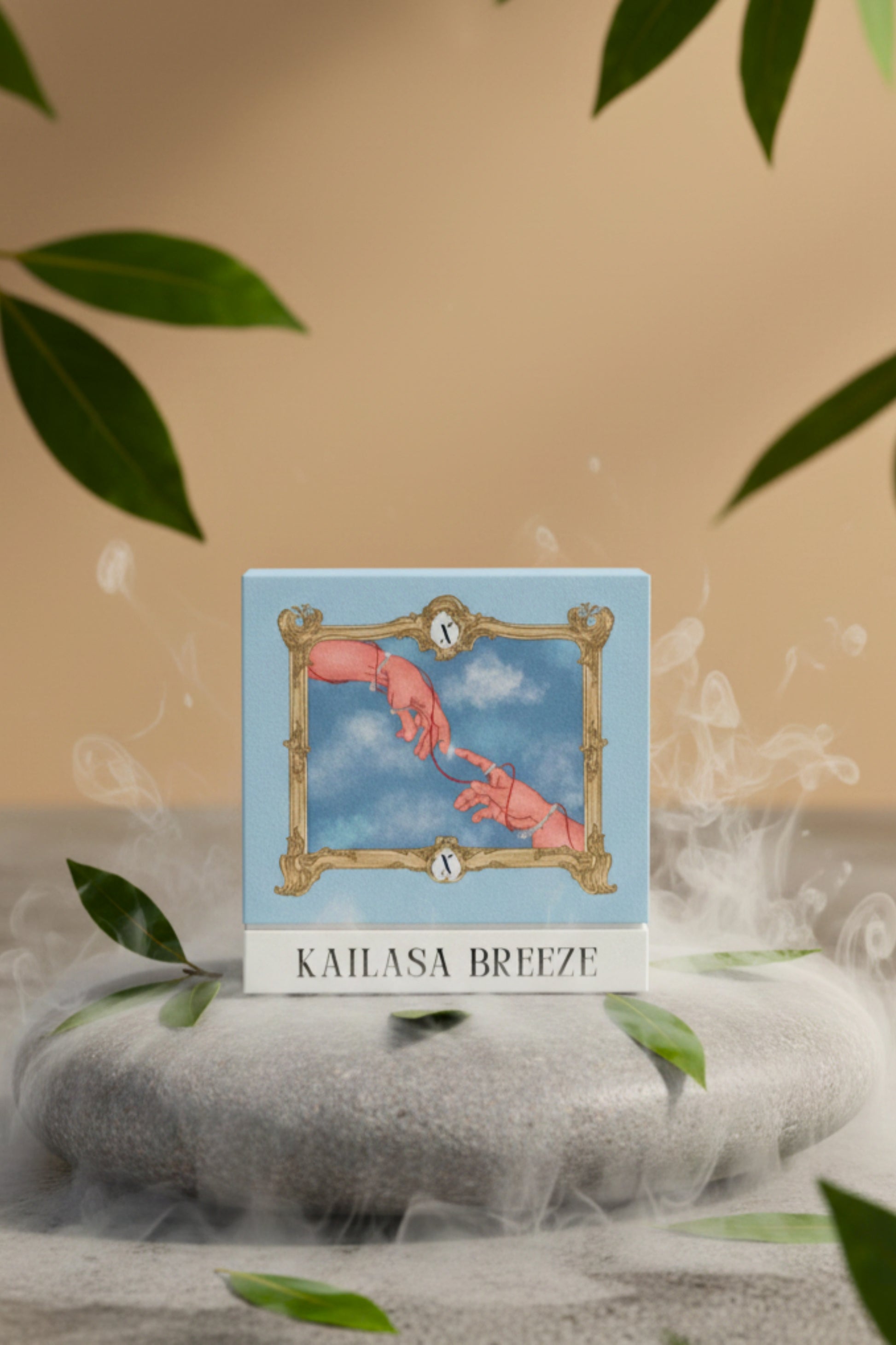 Studio product shot of the XAZINA 'Kailasa Breeze' perfume box, featuring a blue and gold illustration of two hands reaching for each other, connected by a red string, framed by a baroque border. The box is set on a stone surrounded by green leaves and white mist. Represents the XAZINA brand story of connection and luxury fragrance.
