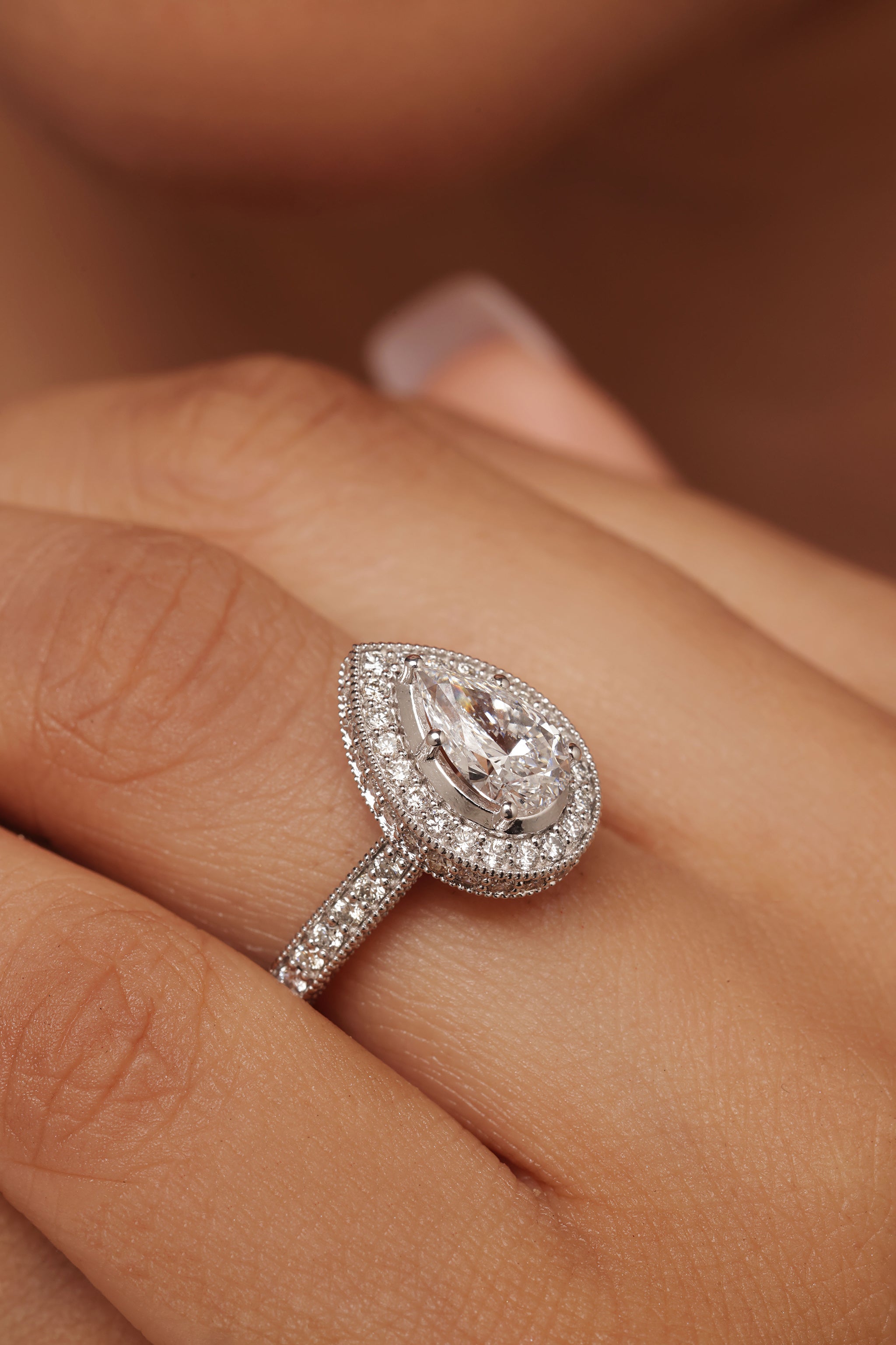 engagement-style ring with a pear diamond center stone with Lab Grown Diamond